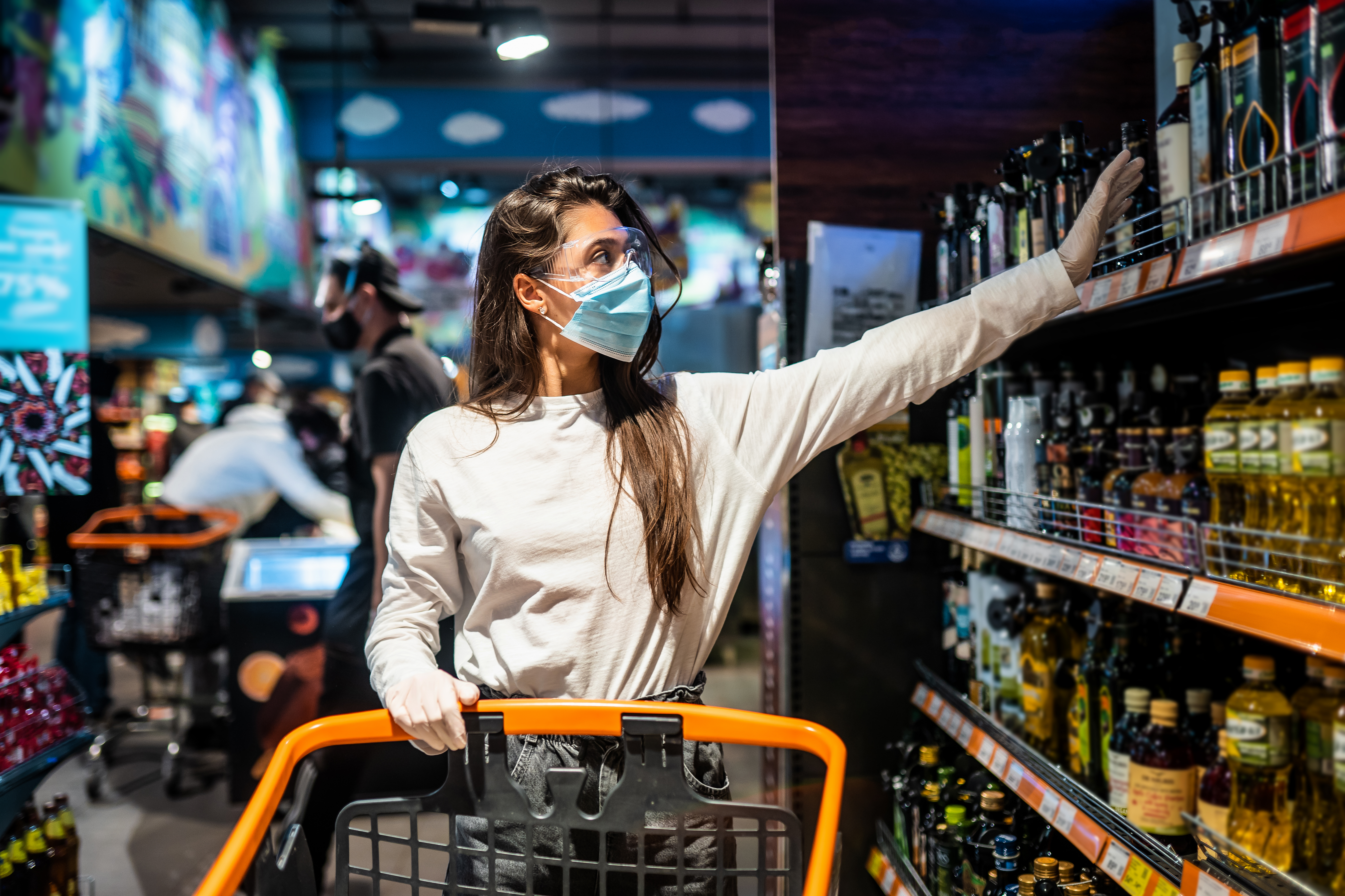 woman-with-the-surgical-mask-and-the-gloves-is-shopping-in-the-supermarket-after-coronavirus-pandemic-the-girl-with-surgical-mask-is-going-to-buy-the-some-food